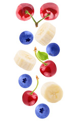 Naklejka na ściany i meble Falling sliced banana and berries isolated on white