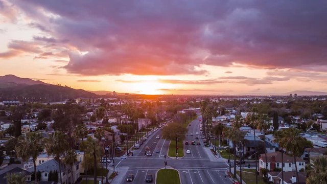 Aerial view of cinematic sunset with heavy colored clouds over Los Angeles