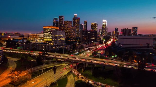 4k aerial time lapse in motion view of Downtown Los Angeles and 110 freeway traffic at night