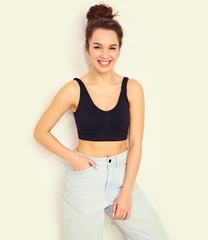 Portrait of young beautiful brunette woman girl model with nude makeup in summer T-shirt top and jeans hipster clothes posing near wall. Going crazy