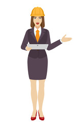 Businesswoman in construction helmet holding a digital tablet PC and showing something beside of her