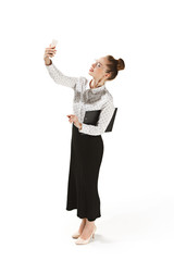 Full length portrait of a smiling female teacher holding a folder isolated against white background