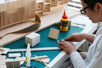 Woman architecture student working on models
