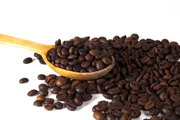 A wooden spoon with coffee beans and cookies. Top view with copyspa