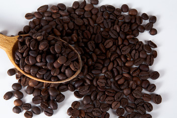 A wooden spoon with coffee beans and cookies. Top view with copyspa