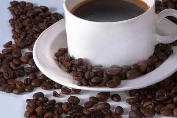 Coffee cup and beans on old kitchen table. Top view with copyspa
