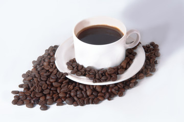 Fototapeta premium Coffee cup and beans on old kitchen table. Top view with copyspa