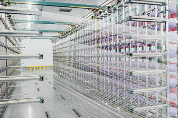 textile yarn on the warping machine. machinery and equipment in a textile factory