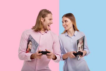 Competitive spirit. Joyful young woman and her boyfriend looking at each other and smiling while...