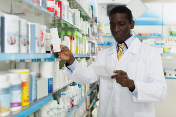  pharmacist looking at prescription searching  drug