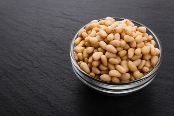 peeled pine nuts on a rustic background