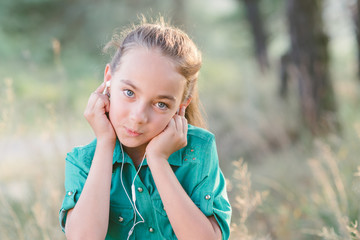 Little cute girl spends his free time outdoors in the woods.