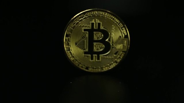 The Gold coin Bitcoin on dark map concept footage.