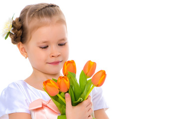 Obraz na płótnie Canvas Little girl with a bouquet of tulips.