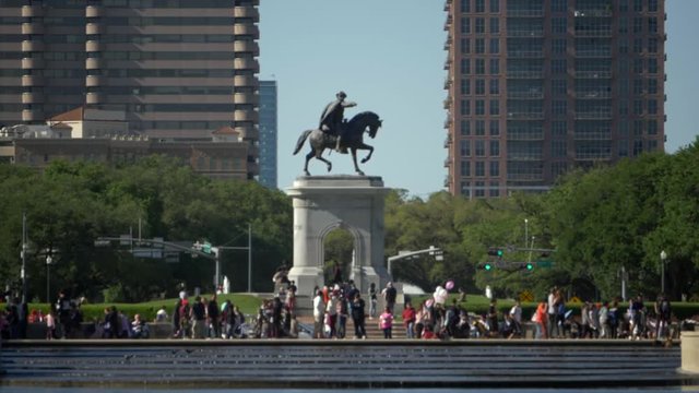 Slow motion view of pedestrian at the around the Sam Houston Monument in Houston, Texas