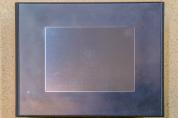 Fototapeta premium Touch panel. Black LCD screen on the stone texture.