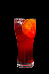 A single-colored transparent cocktail, refreshing in a high glass with ice cubes, one round slice of lemon, orange, with a taste of fruits and berries. Side view Isolated black background
