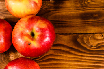 Ripe red apples on the wooden table. Top view