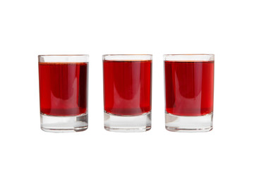 Monochrome transparent cocktails, a set of shots in one row, three servings, with a taste of berries, cherries, strawberries, greiprut, cola, with spices. Side view Isolated white background.