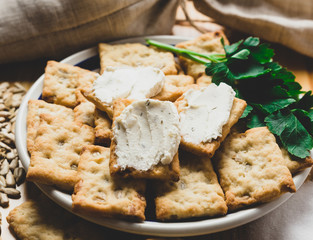 Italian cracker on a plate with melted cheese and herbs