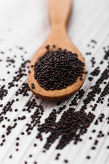 fresh amaranth grains on a rustic background