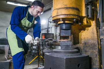 The man is working in the workshop.