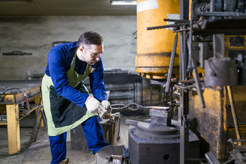 Hammer and forceps lie on the anvil