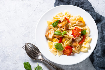 Pasta with chicken and vegetables top view on stone table. 