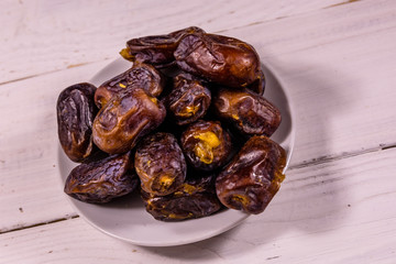 Date fruits on the white wooden table