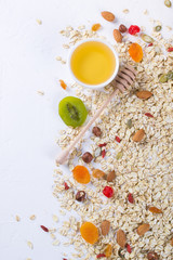 Oat flakes and various delicious ingredients for healthy breakfast, top view,