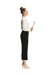 Full length portrait of a female teacher holding a folder isolated against white background