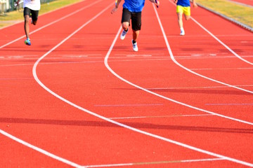 Athletes at the end of a red track speed race