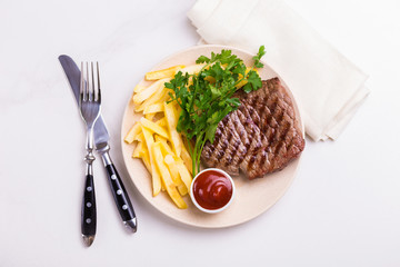 Grilled beef steak with tomatoes, french fries. Barbecue, bbq meat