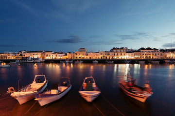 Fishing boats at the bank on the Gilao River in the Old Town of Tavira, Algarve, Portugal.