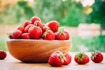 Wooden Bowl Filled With Fresh Ripe Red Strawberries On Wooden Table