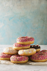 Stack of pink and white donats over blue background