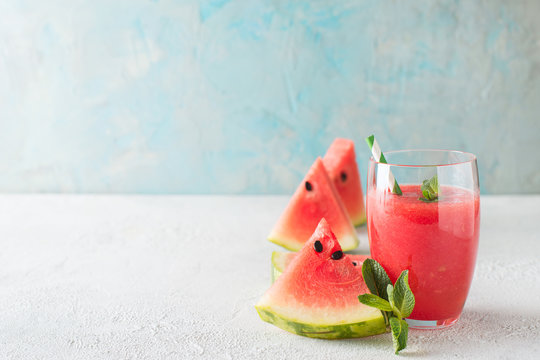 Watermelon smoothie with slice of fruit and leaf of mint