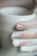 Fototapeta premium Handcrafted on a potter's wheel,Hands make clay from various items for home and sale in the store and at the exhibition, ceramic items are made in hand, the clay billet becomes a ceramic dish