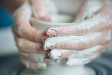 Handcrafted on a potter's wheel,Hands make clay from various items for home and sale in the store and at the exhibition, ceramic items are made in hand, the clay billet becomes a ceramic dish
