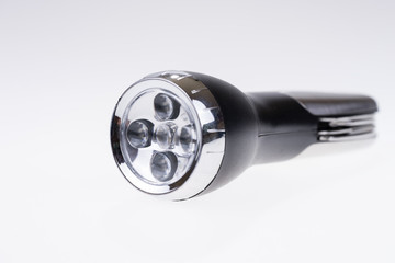 Metallic portable LED flashlight isolated on white