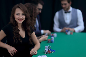 modern business woman sitting at craps table in a casino.