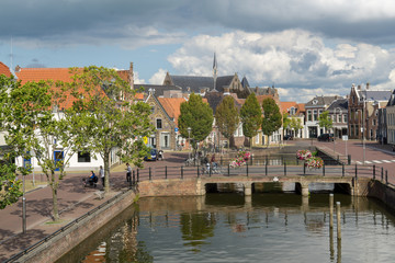 Fototapeta na wymiar Cityscape of Sneek at the Balthuskade and Prinsengracht (Canal) and the Rienck Bockemakade seen from the Waterpoort (Water gate) in the province Friesland, The Netherlands