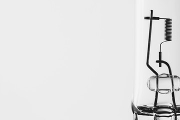 Detail monochrome image of filament from dipped beam bulb close-up with copy space.