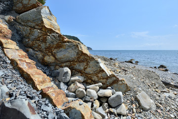A beautiful rocky shore with sharp edges overlooking the sea