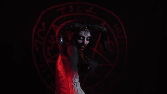 Demoness bends in a ritual dance to summon demons