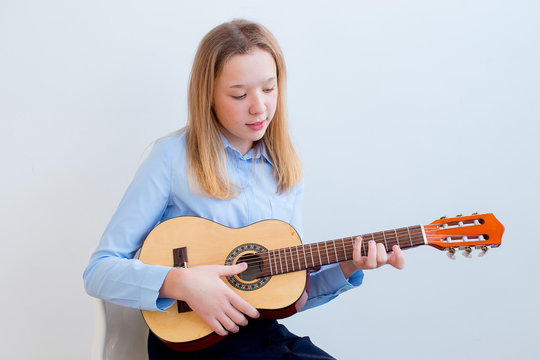 Girl playing a guitar