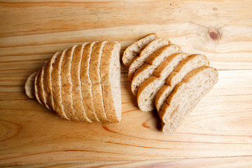 A loaf of wholegrain bread on a wooden background