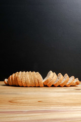 A loaf of wholegrain bread on a wooden background