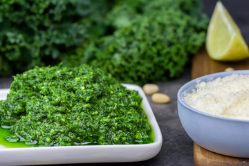Pesto made from kale, cheese grana padano, lime, pine nuts and garlic - close up