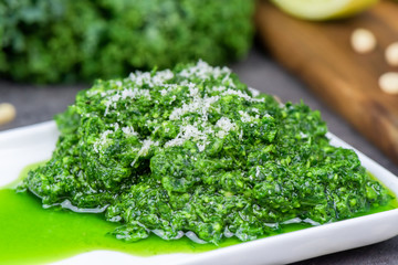 Fototapeta premium Pesto made from kale, cheese grana padano, lime, pine nuts and garlic - close up